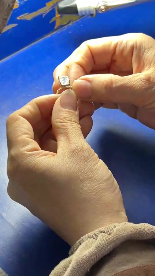 A LUMEN18 craftsperson inspecting a ring at the workbench
